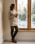 Black | The Wintermae Legging worn with a knit skirt and boots